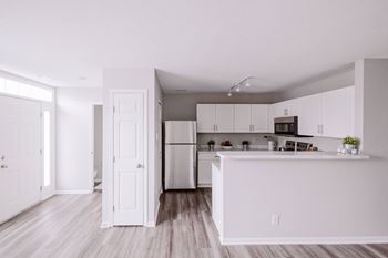 Modern white chef’s kitchen with upgraded appliances*